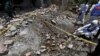 FILE - Investigators collect evidence at the site of an explosion, in Lahore, Pakistan, June 23, 2021.