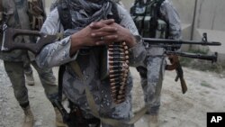 FILE - Afghan security forces guard a checkpoint in Spein Boldak at the border with Pakistan, Kandahar province, Afghanistan, Jan. 25, 2016.