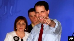 FILE - Wisconsin Republican Gov. Scott Walker reacts at his victory party in Waukesha after winning a recall election, June 5, 2012.