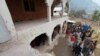 Locals gather near a house that was damaged, according to them, by cross-border shelling, in Neelum Valley, in Pakistan-administrated Kashmir, Nov. 13, 2020.