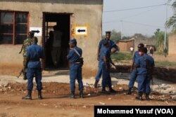 Security forces stand guard at the polling station in Cibitoke neighborhood, Bujumbura. The station experienced low voter turnout after the sounds of gunfire were heard around the center.