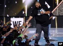 FILE - DJ Khaled greets the audience at WE Day California at the Forum in Inglewood, California.