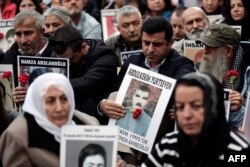 Selahattin Demirtas (C), co-leader of Turkey's pro-Kurdish Peoples' Democratic Party (HDP), attends a gathering of "Saturday Mothers" at Galata Sarai Square in Istanbul on October 31, 2015 on the eve of the country's general election.