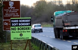A poster against a hard border stands on the border between Northern Ireland and the Republic of Ireland near the town of Derrylin, Northern Ireland, Dec. 12, 2018.