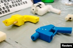 FILE - Seized plastic handguns created with 3-D printing technology are displayed at Kanagawa police station in Yokohama, south of Tokyo, May 8, 2014.