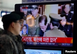 FILE - South Korean soldiers walk past a television showing reports on the execution of Jang Song Thaek, who is North Korean leader Kim Jong Un's uncle, at a railway station in Seoul, Dec. 13, 2013.