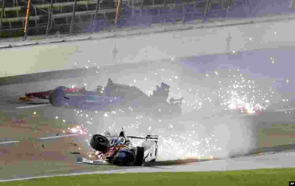 Jack Hawksworth, front, of England and Mikhail Aleshin, rear, of Russia, crash in Turn 4 late in the IndyCar auto race at Texas Motor Speedway in Fort Worth, Texas, Aug. 27, 2016.