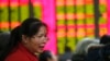 FILE - An investor speaks at a private securities company in Shanghai, China. 