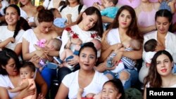 FILE - Mothers nurse their children to mark the World Breastfeeding Week to promote global support for breastfeeding in Ciudad Juarez, Mexico, Aug. 4, 2018.