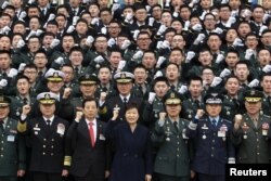 FILE - South Korean President Park Geun-Hye cheers with new military officers during a military commissioning ceremony at Gyeryongdae, South Korea's main military compound, March 4, 2016