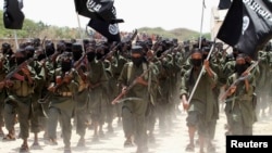 FILE - Recruits belonging to Somalia's al Shabaab rebel group march during a parade at a training base in 2011.