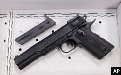 FILE - The fake handgun taken from 12-year-old Tamir Rice is displayed in November 2014 after a news conference in Cleveland.