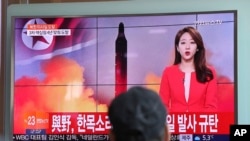 A man watches a TV news program reporting about North Korea's missile launch in Seoul, South Korea, Feb. 12, 2017. The letters read "The ruling and the opposition parties denounce North Korea's missile launch."