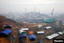 Rohingya refugees walk down a hill at Balukhali refugee camp near Cox's Bazar, Bangladesh Nov. 4, 2017