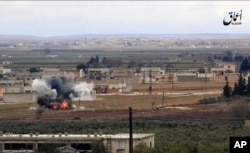 FILE - This image made from militant video posted online by the Aamaq News Agency, a media arm of the Islamic State group on Jan. 9, 2017, purports to show the moment of a Turkish missile strike, in the town of al-Bab.