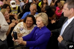 Democratic presidential candidate Hillary Clinton meets with attendees during a campaign stop at the Frontline Outreach Center in Orlando, Florida, Sept. 21, 2016.