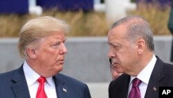 FILE - U.S. President Donald Trump talks to Turkish President Recep Tayyip Erdogan at NATO headquarters in Brussels, Belgium, July 11, 2018.