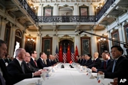FILE - U.S. and Chinese delegations meet in the Indian Treaty Room in the Eisenhower Executive Office Building on the White House complex, during continuing meetings on the U.S.-China bilateral trade relationship, Feb. 21, 2019, in Washington.