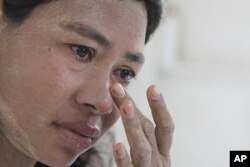 FILE - Burmese Ma Moe, who is infected with HIV, breaks into tears as she recalls how her husband died of AIDS. AIDS in Asia, has steadily worsened out of the spotlight, June 9, 2009.