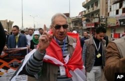 A teacher at Mosul University chants slogans against extremists as students and activists celebrate the liberation of the university from Islamic State militants, Jan. 22, 2017.