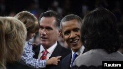 U.S. President Barack Obama and Republican presidential nominee Mitt Romney greet family members following the final U.S. presidential debate in Boca Raton, Florida October 22, 2012.