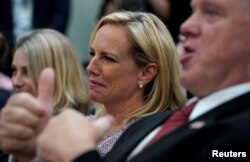 Acting Immigration and Customs Enforcement Director Thomas Homan gives a thumbs-up as he and Homeland Security Secretary Kirstjen Nielsen listen during an immigration event hosted by President Donald Trump at the White House in Washington, June 22, 2018.