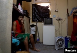 An Asian worker rests at his accommodation in Qadisiya labor camp, Saudi Arabia Aug. 17, 2016.