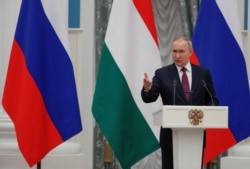 Russian President Vladimir Putin speaks during a news conference in Moscow, Russia, Feb. 1, 2022.