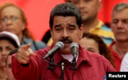 FILE - Venezuela's President Nicolas Maduro criticizes U.S. President Donald Trump at a rally in Caracas, Aug. 14, 2017.