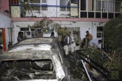 Afghan people are seen inside a house after U.S. drone strike in Kabul, Afghanistan, Sunday, Aug. 29, 2021. A U.S. drone strike destroyed a vehicle carrying "multiple suicide bombers" from Afghanistan's Islamic State affiliate on Sunday before they could