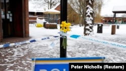 U.K., March 19, 2018 -- Flowers are left at the cordon near the tent covering the park bench where former Russian intelligence officer Sergei Skripal and his daughter Yulia were found poisoned in Salisbury, Britain.