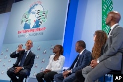 FILE - Then-President Barack Obama, left, takes part in a panel discussion at the Global Entrepreneurship Summit at the United Nations Compound, July 25, 2015, in Nairobi.