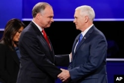 Republican vice-presidential nominee Gov. Mike Pence, right, and Democratic vice-presidential nominee Sen. Tim Kaine shake hands during the vice-presidential debate at Longwood University in Farmville, Va.