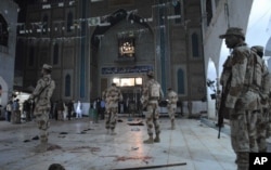 Pakistani paramilitary soldiers guard the site of a deadly suicide attack at a shrine in a remote town in Sindh province, Pakistan, Feb. 16, 2017. The attack took at least 72 lives.