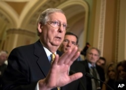 FILE - Senate Majority Leader Mitch McConnell, R-Ky., tells reporters he is delaying a vote on the Republican health care bill while the GOP leadership works toward getting enough votes, at the Capitol in Washington, June 27, 2017.