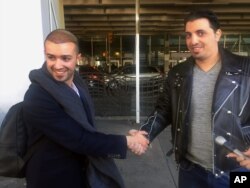 Ammar Alnajjar, left, shakes hands with his cousin, Fahd Alfakih, after coming into New York's JFK International Airport on a flight from Istanbul, Turkey, Feb. 4, 2017.