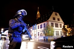 Security forces secure area where a suspect is sought after a shooting in Strasbourg, France, Dec. 11, 2018.