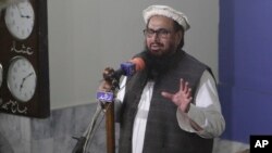 FILE - Hafiz Saeed, head of the Pakistani religious party, Jamaat-ud-Dawa, gives Friday sermon at a mosque in Lahore, Pakistan, Nov. 24, 2017.