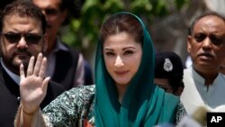 FILE - Maryam Nawaz, center, the daughter of Nawaz Sharif waves while she arrives to talk with media following appearing before a Joint Investigation Team, in Islamabad, Pakistan, July 5, 2017.