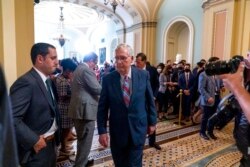 FILE - Senate Minority Leader Mitch McConnell, R-Ky., walks away after speaking with reporters as work continues on the Democrats' Build Back Better Act, massive legislation that is a cornerstone of President Joe Biden's domestic agenda, at the Capitol, i