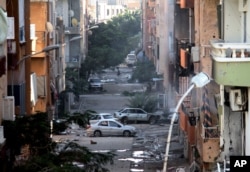 FILE - Damage resulting from clashes between the Libyan military and Islamic militias is seen in Benghazi, Oct. 29, 2014.