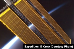 Earth's horizon and the International Space Station's solar panel array, Aug. 2008.