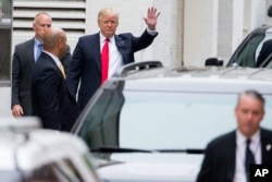 Republican presidential candidate Donald Trump waves as he arrives for a meeting with House Speaker Paul Ryan of Wisconsin, at the Republican National Committee Headquarters on Capitol Hill in Washington, May 12, 2016.