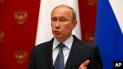Russian President Vladimir Putin speaks at a joint news conference with Swiss Federal President Didier Burkhalter in Moscow, May 7, 2014..