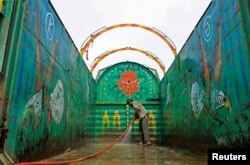 A worker washes a decorated truck in Peshawar, Pakistan, May 2, 2017.