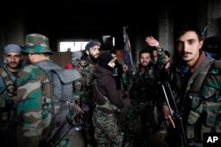 Syrian army soldiers prepare for battle with rebels at the Ramouseh front line, east of Aleppo, Syria, Dec. 5, 2016.