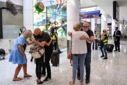 People reunite at Sydney Airport in the wake of COVID-19 border restrictions easing, with fully vaccinated Australians being allowed into Sydney from overseas without quarantine for the first time since March 2020, in Sydney, Nov. 1, 2021.