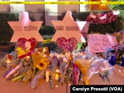 Then memorials for brothers Cecil and David Rosenthal stand next to each other outside the Tree of Life synagogue on Oct. 29, 2018.