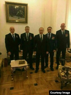 Vladimir Putin appearing with Dmitry Utkin (far right), alleged founder of the mercenary group Wagner, December 2016