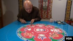 Mandala artist Losang Samten is creating the Mandala of Compassion in the gallery of the Philadelphia Folklore Project (VOA/ J. Soh)